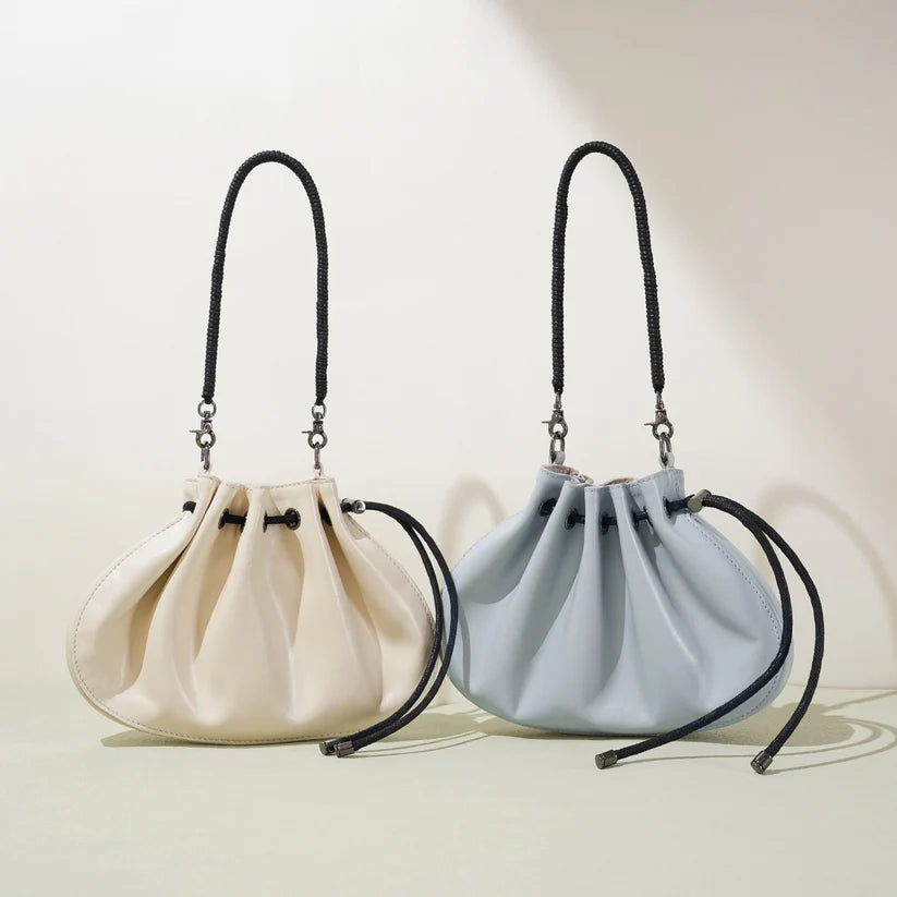 Pleated lambskin bucket bag with a shell-like silhouette