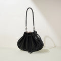 Pleated lambskin bucket bag with a shell-like silhouette