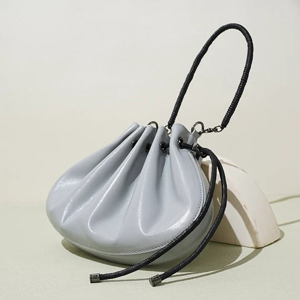 Pleated lambskin bucket bag with a shell-like silhouette